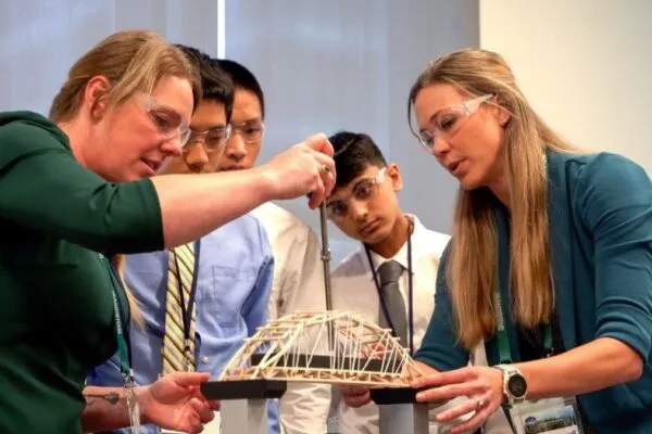 Tied Arch Titans, the 9th and 10th grade winners, are shown here testing the bridge strength to weight ratio. Image courtesy of Bentley Systems. | Bentley Systems Sponsors Student Bridge Contest at AASHTO Spring Meeting