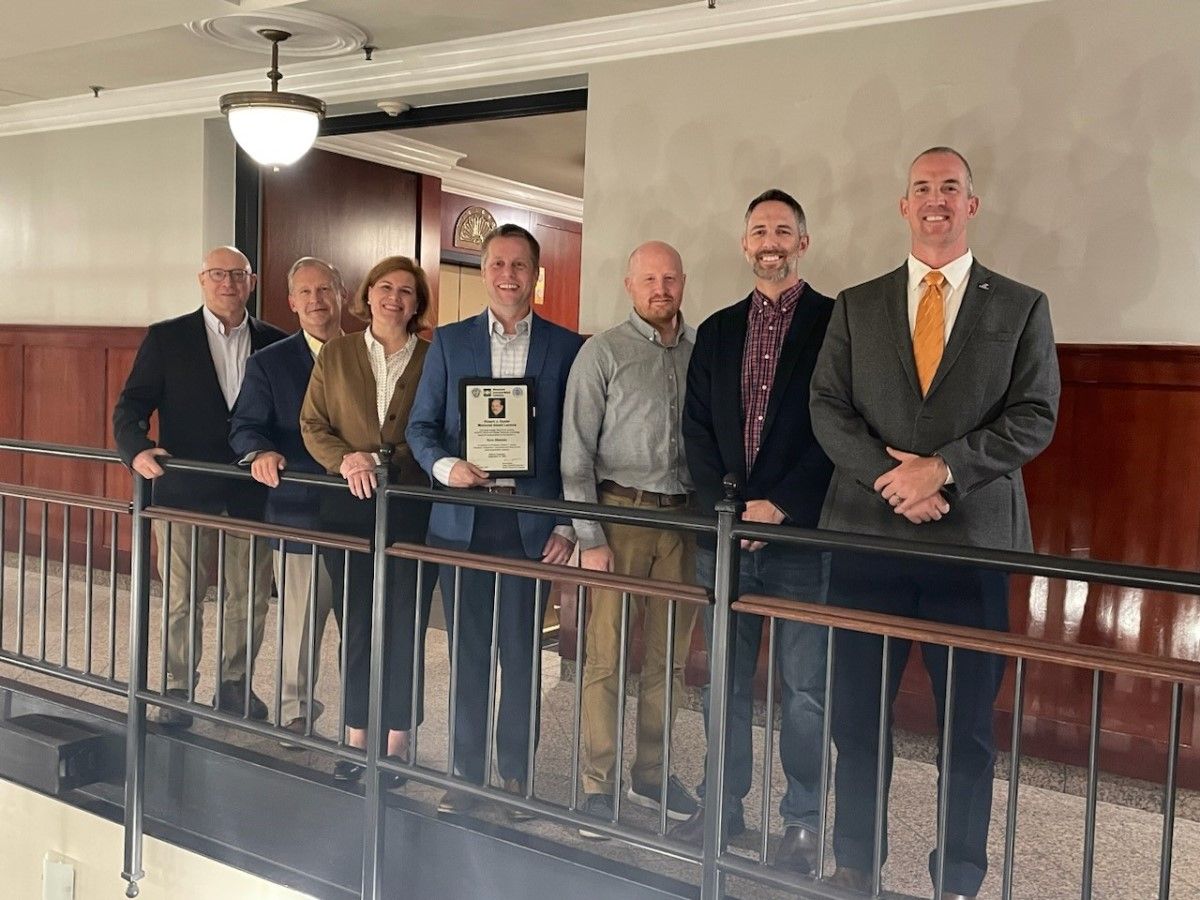 Ryan Sherman holds the plaque commemorating the 2023 Robert J. Dexter Memorial Award Lecture. He is with previous award winners, with the exception of Don White, who nominated Ryan and presented the award to him. Pictured from left to right are: Don White, Georgia Institute of Technology; Robert Connor, Purdue University (2005); Caroline Bennett, University of Kansas in Lawrence (2013); Ryan Sherman, Georgia Institute of Technology (2023); Matthew Hebdon, Virginia Polytechnic Institute and State University (2019, now with The University of Texas at Austin); Matthew Yarnold, Texas A&M University (2021, now with Auburn University) and William Collins, University of Kansas at Lawrence (2022). Photo by AISI. | Ryan Sherman Presents on Steel Additive Manufacturing for the 2023 Robert J. Dexter Memorial Award Lecture