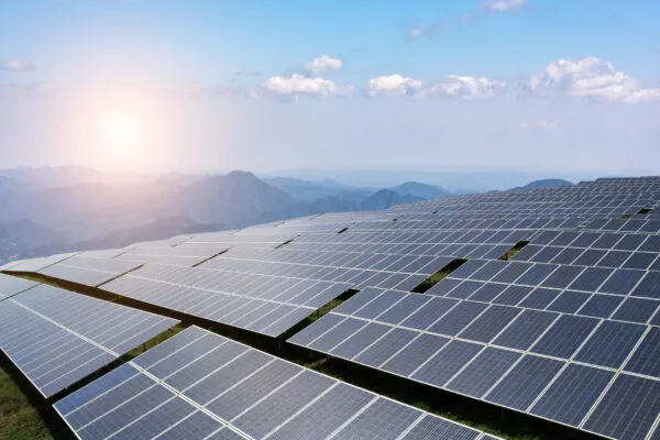 Captivating Solar Panel Field Overlooking Majestic Mountain Landscape | Arcadis joins forces with Schneider Electric and energy solution providers to accelerate resilient infrastructure